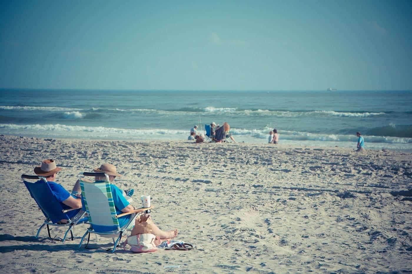 An older couple relaxing on a beach