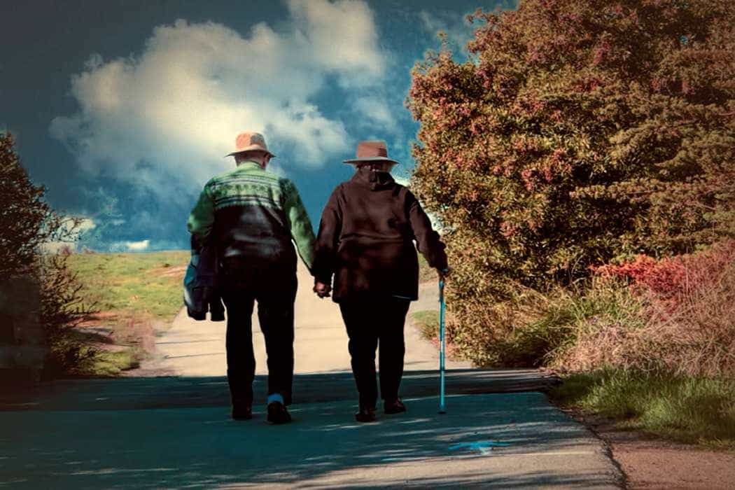 An older couple walking together outdoors